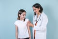 Hispanic woman Doctor injecting vaccine to cute hispanic child girl in Mexico Latin America Royalty Free Stock Photo
