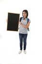 Hispanic woman or female student holding blank blackboard with copy space for adding message Royalty Free Stock Photo