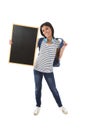 Hispanic woman or female student holding blank blackboard with copy space for adding message Royalty Free Stock Photo