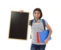 Hispanic woman or female student holding blank blackboard with copy space for adding message Royalty Free Stock Photo