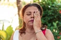 Hispanic woman of fifty years with red hair cover face with hand