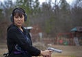 Hispanic Woman Firing Pistol