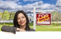 Hispanic Woman in Front of Sold For Sale Sign, House Royalty Free Stock Photo