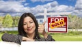 Hispanic Woman in Front of Sold For Sale Sign, House Royalty Free Stock Photo
