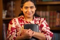 Hispanic Woman Holding Bible and Looking Directly at the Camera Royalty Free Stock Photo