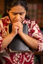 Hispanic Woman Holding Bible and Praying Royalty Free Stock Photo