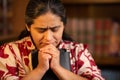 Hispanic Woman Holding Bible and Praying Royalty Free Stock Photo