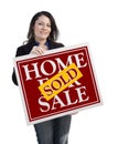 Hispanic Woman Holding Sold Home For Sale Sign on White Royalty Free Stock Photo