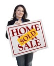 Hispanic Woman Holding Sold Home For Sale Sign on White Royalty Free Stock Photo