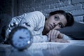 Hispanic woman at home bedroom lying in bed late at night trying to sleep suffering insomnia