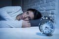 Hispanic woman at home bedroom lying in bed late at night trying to sleep suffering insomnia Royalty Free Stock Photo