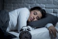 Hispanic woman at home bedroom lying in bed late at night trying to sleep suffering insomnia Royalty Free Stock Photo