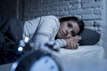 Hispanic woman at home bedroom lying in bed late at night trying to sleep suffering insomnia Royalty Free Stock Photo