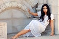 Hispanic woman leaning on a stone wall Royalty Free Stock Photo