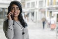 Hispanic woman making a call from her mobile phone Royalty Free Stock Photo