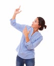 Hispanic woman pointing up her arms Royalty Free Stock Photo