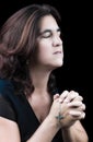 Hispanic woman praying with her eyes closed Royalty Free Stock Photo