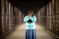 Hispanic Woman Praying While Holding Bible On A Bridge Royalty Free Stock Photo