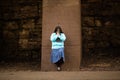 Hispanic Woman Prays By Wall