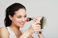 Hispanic woman putting on her makeup Royalty Free Stock Photo