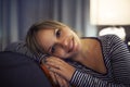 Hispanic woman relaxing on sofa and smiling Royalty Free Stock Photo