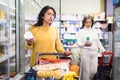 Hispanic woman shopping for milk products in supermarket Royalty Free Stock Photo