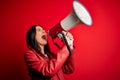 Hispanic woman shouting angry on protest through megaphone Royalty Free Stock Photo