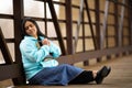 Hispanic Woman Sitting On A Bridge Praying While Holding Bible Royalty Free Stock Photo