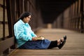 Hispanic Woman Sitting On A Bridge And Reading Bible Royalty Free Stock Photo