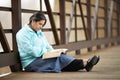 Hispanic Woman Sitting On A Bridge And Reading Bible Royalty Free Stock Photo
