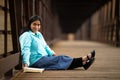 Hispanic Woman Sitting And Reading Bible On A Bridge Royalty Free Stock Photo