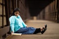 Hispanic Woman Sitting And Reading Bible On A Bridge Royalty Free Stock Photo