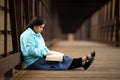 Hispanic Woman Sitting And Reading Bible On A Bridge Royalty Free Stock Photo