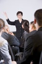 Hispanic woman speaking to group of businesspeople Royalty Free Stock Photo