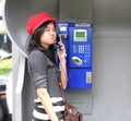 Hispanic woman talking in a public phone Royalty Free Stock Photo