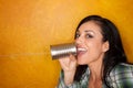 Hispanic woman with tin can telephone Royalty Free Stock Photo