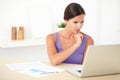 Hispanic woman wondering while working on laptop Royalty Free Stock Photo