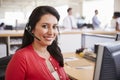 Hispanic woman working in a call centre smiling to camera Royalty Free Stock Photo