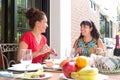 Hispanic women enjoying an outdoor home meal together Royalty Free Stock Photo