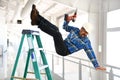 Hispanic Worker Falling from Ladder Royalty Free Stock Photo