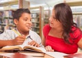 Hispanic Young Boy and Famle Adult Studying At Library