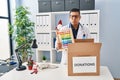 Hispanic young doctor man donating toys at the clinic puffing cheeks with funny face