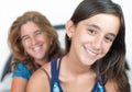Hispanic young girl and her mother smiling