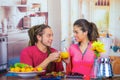 Hispanic young healthy couple enjoying breakfast together, sharing fruits, drinking orange juice and smiling, home Royalty Free Stock Photo