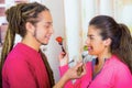 Hispanic young healthy couple enjoying breakfast together, sharing strawberries and smiling, home kitchen background Royalty Free Stock Photo