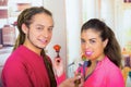 Hispanic young healthy couple enjoying breakfast together, sharing strawberries and smiling, home kitchen background Royalty Free Stock Photo