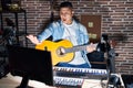 Hispanic young man playing classic guitar at music studio doing stop gesture with hands palms, angry and frustration expression Royalty Free Stock Photo