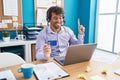 Hispanic young man working at the office doing online shopping smiling with an idea or question pointing finger with happy face, Royalty Free Stock Photo