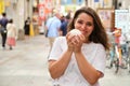 Hispanic young woman eating nikuman at Dotonbori street in Osaka, Japan. Royalty Free Stock Photo