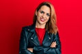 Hispanic young woman wearing black leather jacket happy face smiling with crossed arms looking at the camera Royalty Free Stock Photo